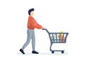 Young man purchaser carrying supermarket shopping cart full of groceries. Male buyer pushing grocery store basket