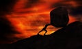 Young man Pushing uphill Big Rock At sunset. Businessman Push The Heavy Stone up the top of mountain. Royalty Free Stock Photo