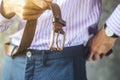 Young Man Puts on a Belt in Trousers Close Up