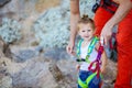 Young man putting climbing gear on his little daughter Royalty Free Stock Photo