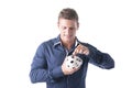 Young man putting coin in piggy-bank, isolated Royalty Free Stock Photo