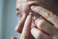 Young man putting contact lens on eye Royalty Free Stock Photo