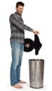 Young man putting dirty socks in a laundry basket Royalty Free Stock Photo