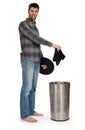 Young man putting dirty socks in a laundry basket Royalty Free Stock Photo