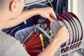 Young man putting a dishwashing machine Royalty Free Stock Photo