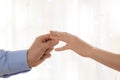 Young man putting engagement ring on fiancee's finger Royalty Free Stock Photo