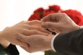 Young man putting engagement ring on fiancee's finger Royalty Free Stock Photo