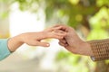 Young man putting engagement ring on fiancee's finger Royalty Free Stock Photo