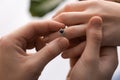 Young man putting engagement ring on fiancee's finger, closeup Royalty Free Stock Photo