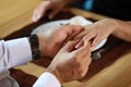 Young man putting engagement ring on fiancee's finger in restaurant Royalty Free Stock Photo