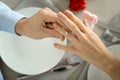 Young man putting engagement ring on fiancee's finger at romantic date Royalty Free Stock Photo