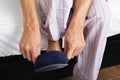 Young man putting on his slippers