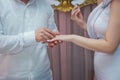 Young man putting ring on finger of his fiancee after marriage proposal, closeup .Wedding hands of a bride and groom . Groom put a Royalty Free Stock Photo