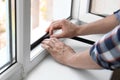 Young man putting sealing foam tape Royalty Free Stock Photo