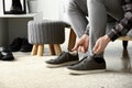 Young man putting on shoes in dressing room Royalty Free Stock Photo