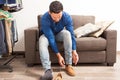 Young man putting shoes on in dressing room Royalty Free Stock Photo