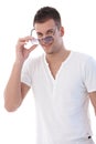 Young man putting on sunglasses smiling Royalty Free Stock Photo