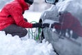 Young man putting winter chains on car Royalty Free Stock Photo