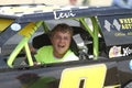 Young man in race car in a parade in small town America