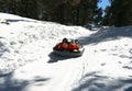 A Young Man Races Down a Snowy Hill in Winter Royalty Free Stock Photo