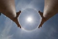 The young man raised his hand to the sky when he saw the natural phenomenon around the sun and made a religious homage to ask for