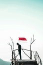 A young man raises the red and white flag, the Indonesian state flag Royalty Free Stock Photo