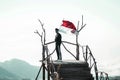 A young man raises the red and white flag, the Indonesian state flag Royalty Free Stock Photo