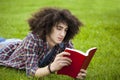 Young man read book in grass Royalty Free Stock Photo
