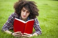 Young man read book in grass Royalty Free Stock Photo