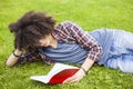 Young man read book in grass Royalty Free Stock Photo