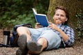 young man read book and repose in grass Royalty Free Stock Photo