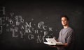 Young man reading a book with alphabet letters