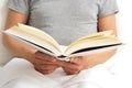 Young man reading a book in bed Royalty Free Stock Photo