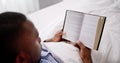 Young Man Reading Book On Bed Royalty Free Stock Photo