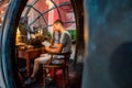 Young man reading a book in a fairytale submarine.