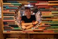 Young man reading a book in the Last Book Store in LA. Royalty Free Stock Photo