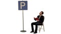 Young man reading a book near parking sign on white background isolated Royalty Free Stock Photo