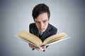 Young man is reading a book. View from above