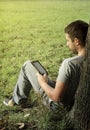 Young man reading e-book Royalty Free Stock Photo