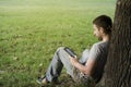 Young man reading e-book