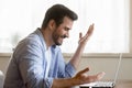 Young man reading email with unbelievable good news