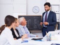 Young man is reading financial report to colleagues on meeting Royalty Free Stock Photo