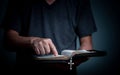 Young man reading Holy Bible and pointing on the word Royalty Free Stock Photo