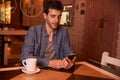 Young man reading message in restaurant Royalty Free Stock Photo