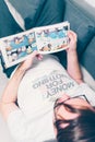 Young man reading a Moomin book