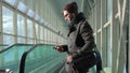 Young man reading an SMS while standing in the subway Royalty Free Stock Photo