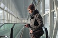 Young man reading an SMS while standing in the subway Royalty Free Stock Photo