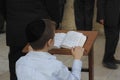 Young man reading from the Toran during Shabbat in Jerusalem