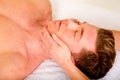 Young man receives a face massage Royalty Free Stock Photo