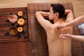 Young man receiving back massage in spa Royalty Free Stock Photo